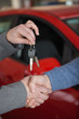 People shaking hands while holding keys