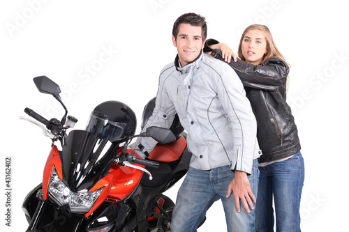 Photo: Couple posing next to motorcycle Couple posing next to motorcycle