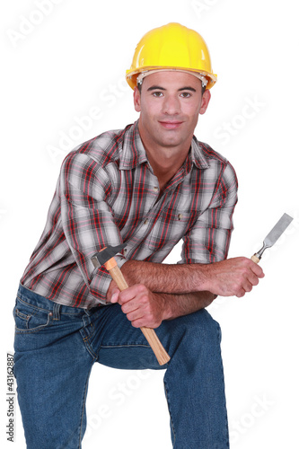 Photo: Carpenter with a hammer and chisel Carpenter with a hammer and chisel
