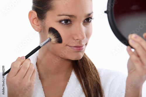 Photo: Woman applying blusher Woman applying blusher