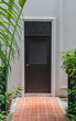 Doorway, green leaves, white building