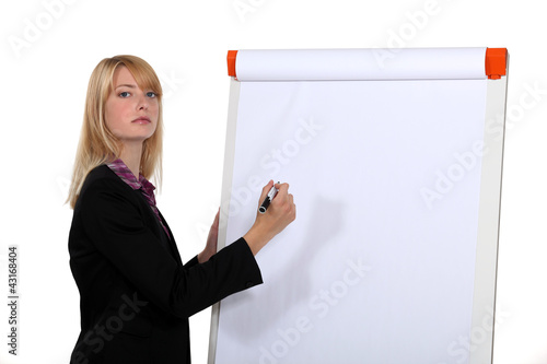 Photo: Blond businesswoman about to write on white-board Blond businesswoman about to write on white-board