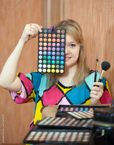 Photo: Female visagiste with cosmetics Female visagiste with cosmetics