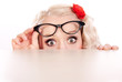 Foto: Funny girl hiding behind a table Funny girl hiding behind a table