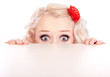Foto: Funny girl hiding behind a table Funny girl hiding behind a table