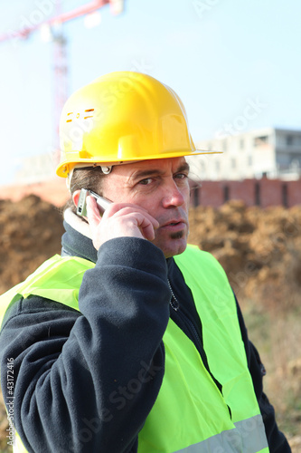 Photo: Foreman with a cellphone Foreman with a cellphone