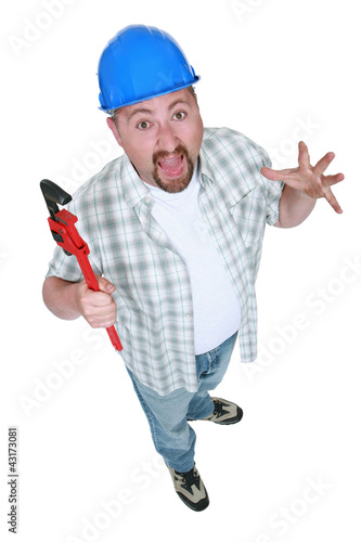 Photo: Surprised tradesman holding a pipe wrench Surprised tradesman holding a pipe wrench