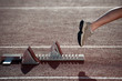 Athlete leaving the starting blocks for a sprint run on a track