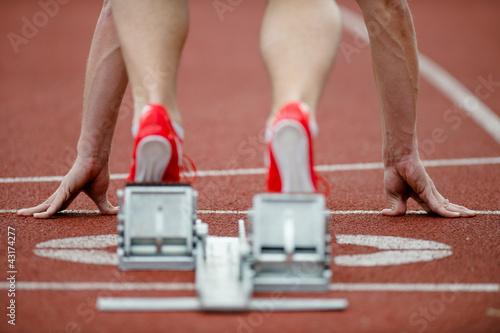 Photo: Detailed view of a sprinter wearing sprinting shoes with spikes, Detailed view of a sprinter wearing sprinting shoes with spikes,
