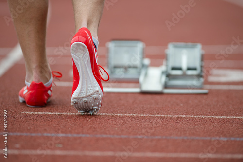 Photo: Professional sprinter walking towards the starting line and star Professional sprinter walking towards the starting line and star