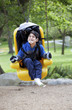Photo: Father pushing disabled son on handicap swing Father pushing disabled son on handicap swing