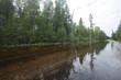 Flooded road after heavy rain, the asphalt has been damaged