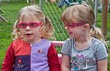 Two Toddler Girls Wearing Sunglasses Outside Playing