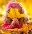 Happy girl in autumn park