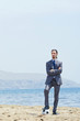 Businessman with football on beach