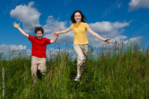 Photo: Girl and boy running, jumping outdoor Girl and boy running, jumping outdoor