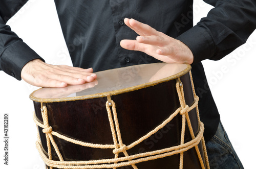 Photo: Drummer with drum playing on white Drummer with drum playing on white