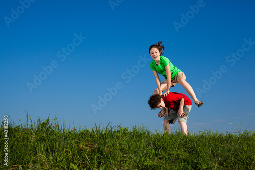 Photo: Girl and boy running, jumping outdoor Girl and boy running, jumping outdoor