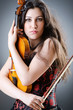 Female violin player against background