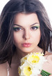 Beautiful girl face with spring flower - daffodil narcissus