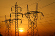 group of high voltage pole against sun