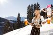 sexy woman in snow and mountains serving beer