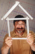 man with folding rule in the shape of a house
