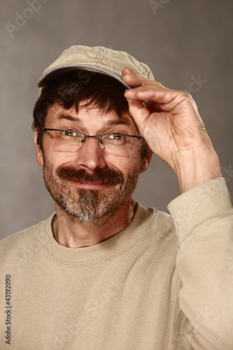 Photo: man with baseball cap greeting friendly man with baseball cap greeting friendly