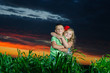 group of happy children playing on meadow, sunset, summertime