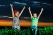 group of happy children playing on meadow, sunset, summertime