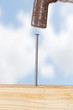Hammer and nail with wooden board