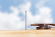 Hammer and nail with wooden board