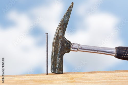 Photo: Hammer and nail with wooden board Hammer and nail with wooden board