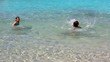 little girls playing in beach water in ibiza island
