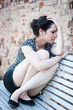 Depressed young woman sitting on a bench in an urban area
