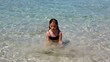 beautiful little girl playing in ibiza beach on vacation
