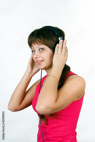 Photo: attractive young girl listening to music attractive young girl listening to music
