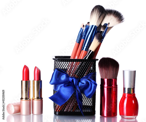 Photo: make-up brushes in holder and cosmetics isolated on white make-up brushes in holder and cosmetics isolated on white