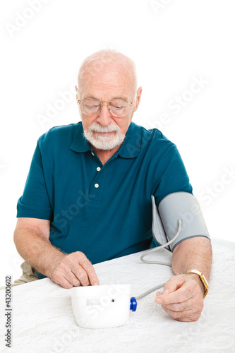 Photo: Senior Man Takes His Blood Pressure Senior Man Takes His Blood Pressure