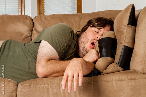 Photo: Man taking a quick nap on the couch Man taking a quick nap on the couch