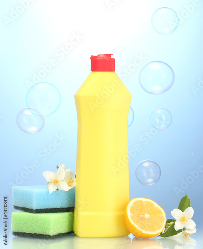 Photo: Dishwashing liquid with sponges and lemon with flowers Dishwashing liquid with sponges and lemon with flowers