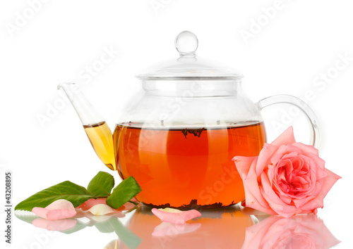 Photo: teapot of tea with rose isolated on white teapot of tea with rose isolated on white