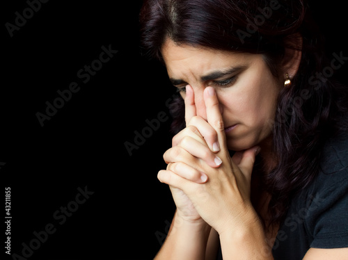 Photo: Stressed woman with a thoughtful sad look isolated on white Stressed woman with a thoughtful sad look isolated on white