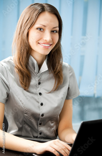 Photo: Young business woman with laptop Young business woman with laptop