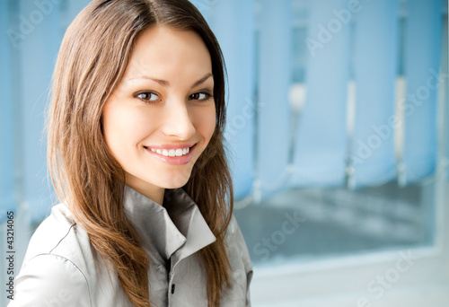 Photo: Young cheerful smiling businesswoman Young cheerful smiling businesswoman