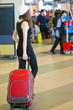 Photo: A woman with luggage in the airport A woman with luggage in the airport