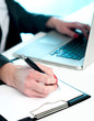Closeup of woman copying data from laptop