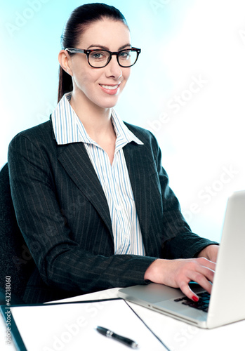 Photo: Corporate woman typing on laptop Corporate woman typing on laptop