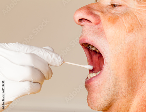 Photo: DNA swab of saliva taken from senior man DNA swab of saliva taken from senior man