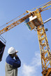building engineer directing large construction crane